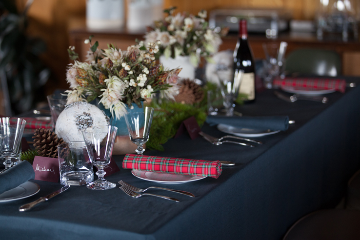 Christmas Table Setting with Forest Green Pure Linen Tablecloth, Red Plaid Napkin and White Holiday Floral Display