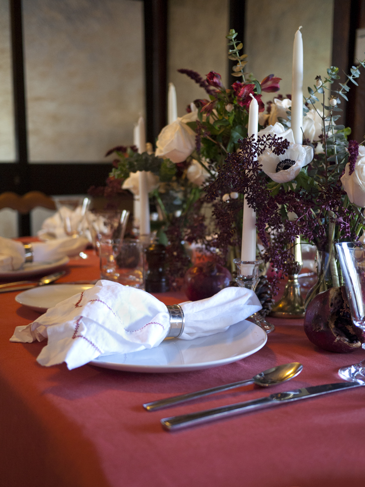 Traditional Christmas brunch in the Hollywood Hills with white anemone and rose centerpieces and white linen napkins with red hemstitch