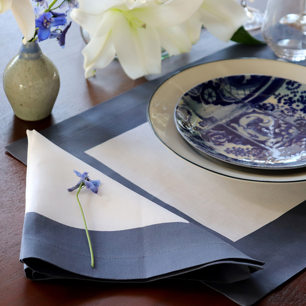 White linen napkin placemat with navy blue border