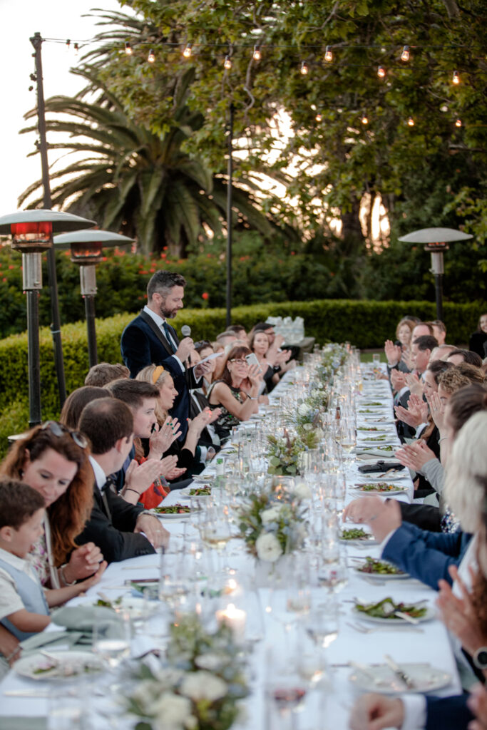 Long wedding table outdoor spring wedding California Malibu speeches low floral centerpieces