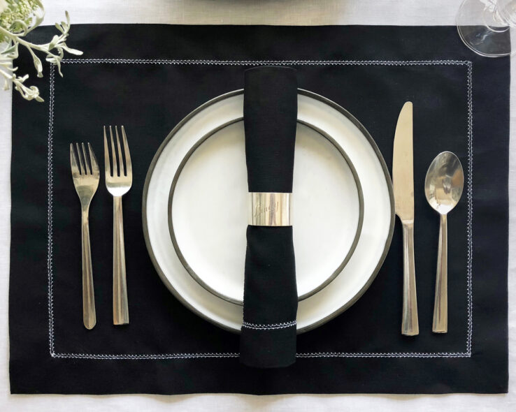 black linen napkin with white hemstitch trim 