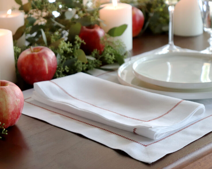 holiday entertaining white hemstitched linen napkin red trim Christmas placesetting 